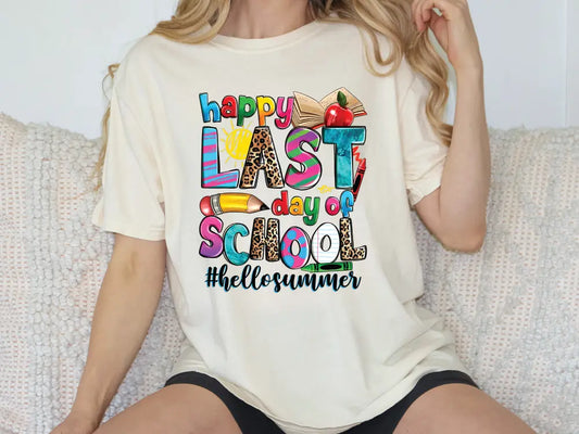 a woman sitting on a couch wearing a t - shirt that says happy last school