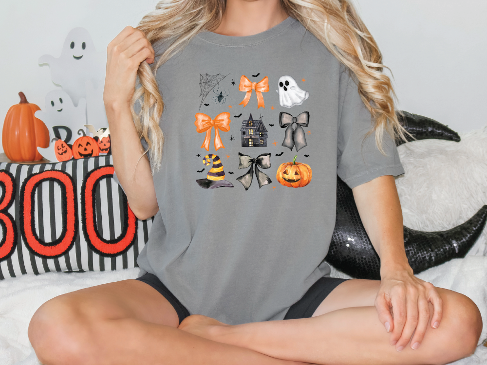 a woman sitting on a bed wearing a halloween t - shirt