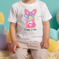 a little boy sitting in front of a bunch of balloons