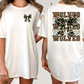 A woman wearing a white t-shirt with a camouflage pattern and the text "WOLVES" printed on the back.