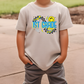 a young boy standing on a sidewalk with his hands in his pockets