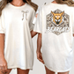 two different views of a white t-shirt with a graphic design on the back. The design features a cartoon-like depiction of a bear with a fierce expression, and the word "BEARCATS" is written below the bear.