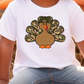 a young boy wearing a white shirt with a turkey on it