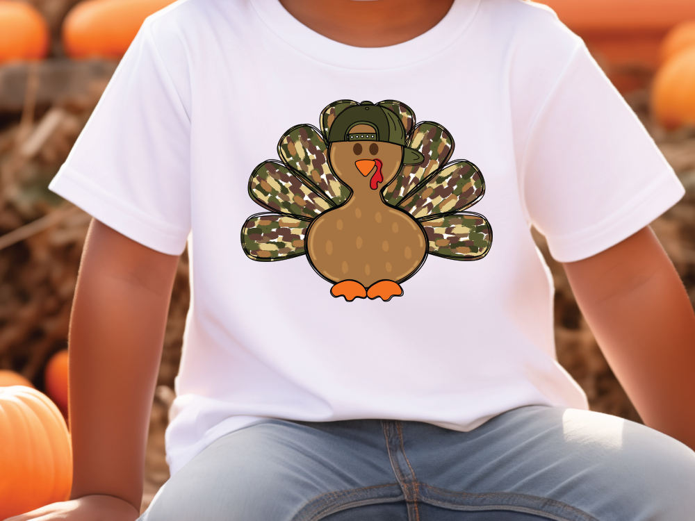 a young boy wearing a white shirt with a turkey on it