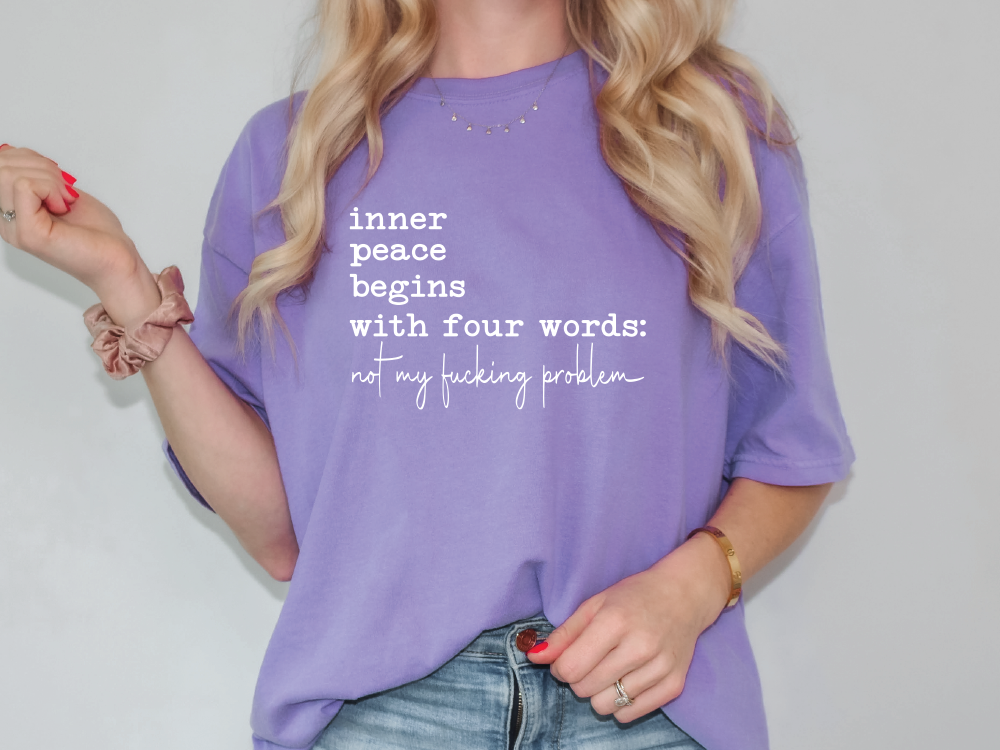 a woman wearing a purple shirt that says inner peace begins with four words