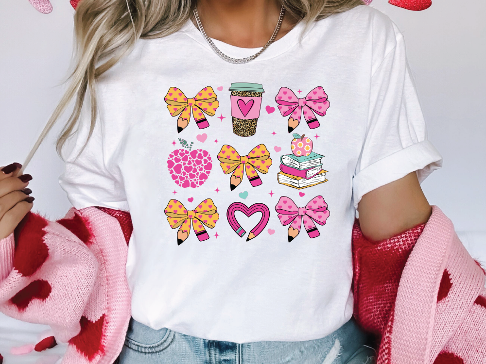 a woman wearing a t - shirt with bows and hearts on it