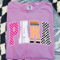 A pink t-shirt with the word "PARA" printed on it, along with various colorful and stylized lettering designs.