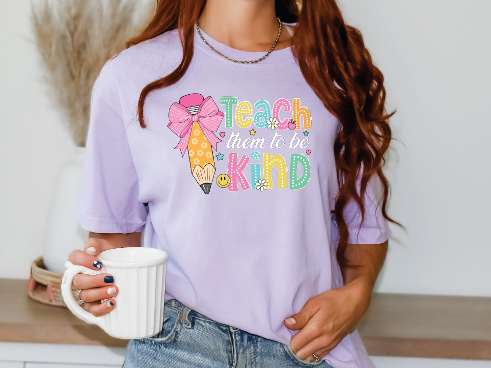 a woman holding a coffee cup and wearing a t - shirt that says teach them