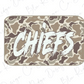 A camouflage-patterned rectangular shape with the word "CHIEFS" written in a bold, white font.