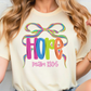 A woman wearing a white t-shirt with a colorful graphic design featuring the word "HOPE" and a ribbon.