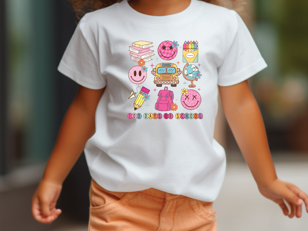 a little girl walking down a street wearing a white shirt with cartoon characters on it