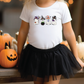 a little girl wearing a white shirt and black skirt