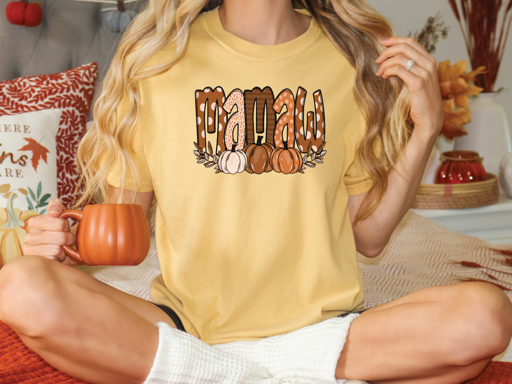 a woman sitting on a bed holding a coffee mug