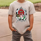 a young boy wearing a gray shirt with a barn on it