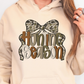 A person wearing a beige hoodie with a graphic design that says "Hunting Season" on it.