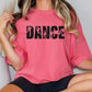 a woman wearing a pink shirt with the word dance on it