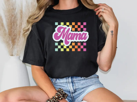 a woman wearing a black shirt with the word mama on it