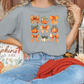 a woman sitting on a couch wearing a t - shirt with butterflies on it