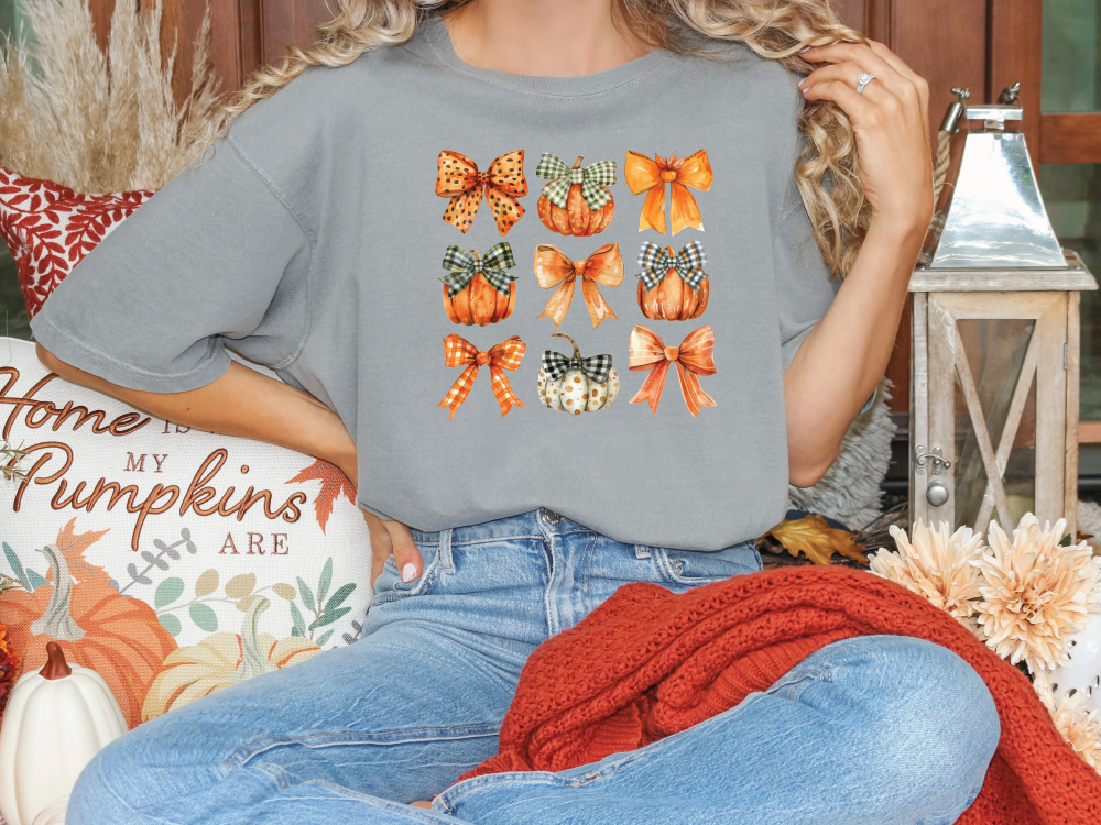 a woman sitting on a couch wearing a t - shirt with butterflies on it