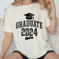 a woman sitting on a couch wearing a graduation shirt