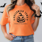 a woman wearing an orange halloween t - shirt