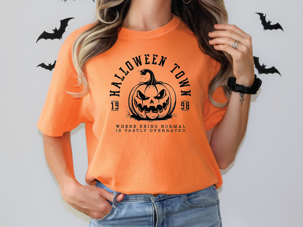 a woman wearing an orange halloween t - shirt