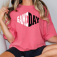 a woman wearing a pink game day shirt