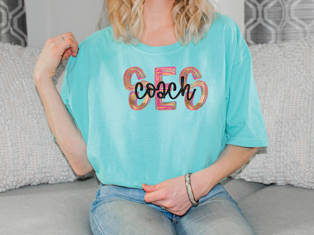 a woman sitting on a couch wearing a blue shirt