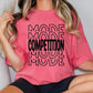 a woman wearing a pink t - shirt with the words made in competition printed on