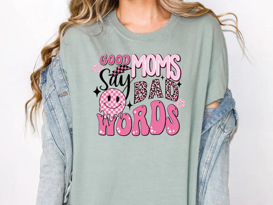 a woman wearing a shirt that says good moms say bad words