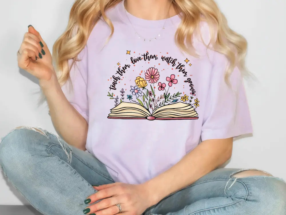 a woman sitting on the floor holding a book