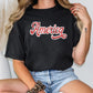 a woman wearing a black shirt with the word america on it