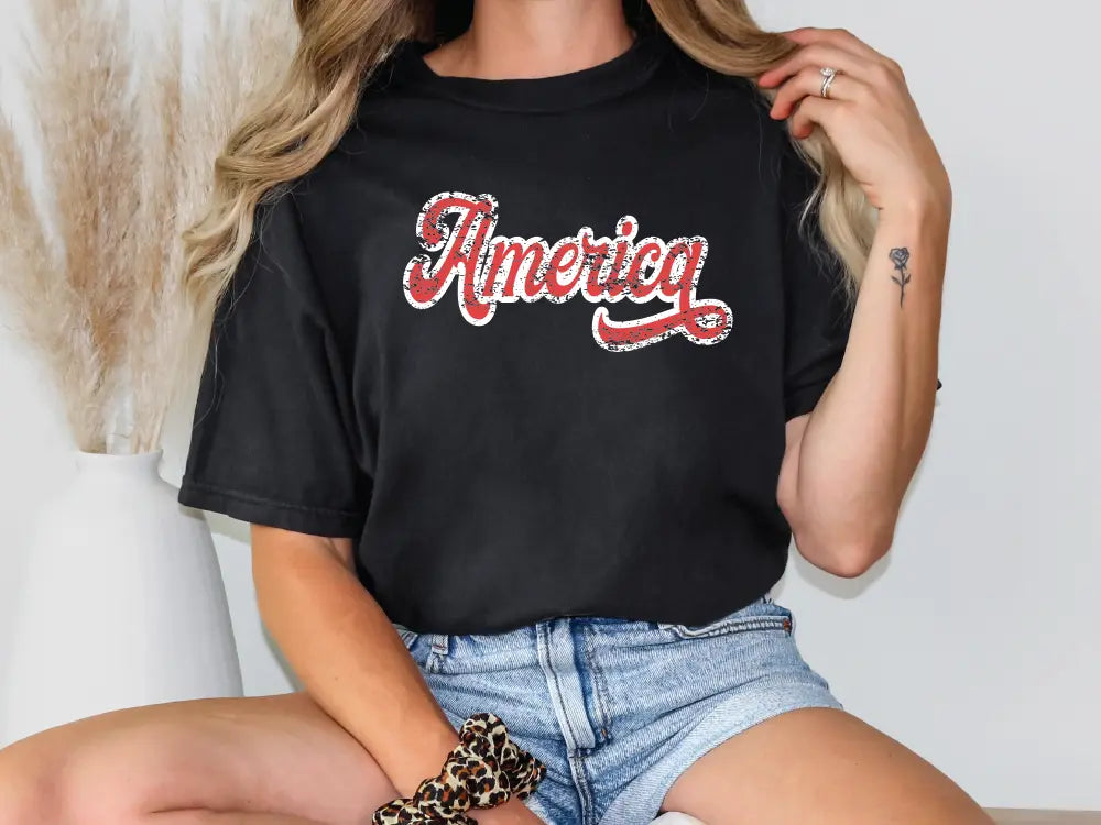 a woman wearing a black shirt with the word america on it