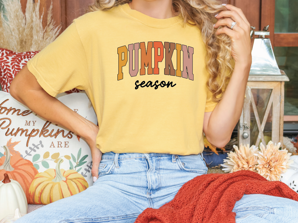 a woman sitting on a couch wearing a yellow shirt