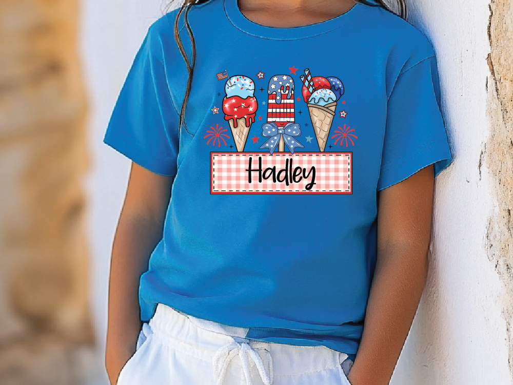 a little girl wearing a blue shirt with ice cream cones on it