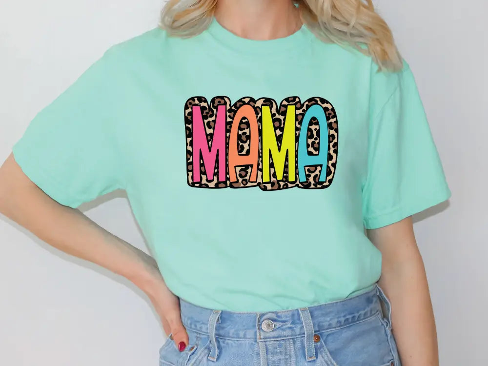 a woman wearing a green shirt with the word mama printed on it