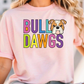 A woman wearing a pink t-shirt with the text "BULL DAWGS" printed on it, along with a cartoon image of a bulldog.