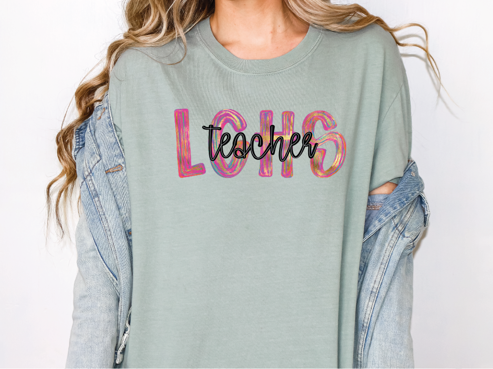 a woman wearing a green shirt with the word teacher printed on it