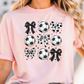 a woman wearing a pink shirt with soccer balls on it