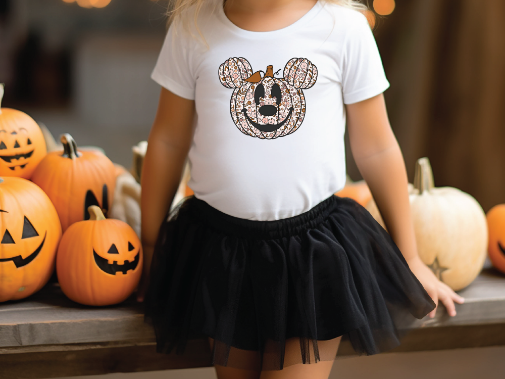 a little girl wearing a mickey mouse shirt