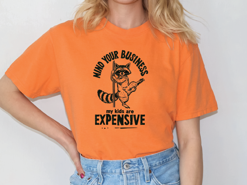 a woman wearing an orange shirt with a raccoon on it