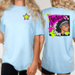 two different views of a woman wearing a light blue t-shirt with a graphic design on the back.