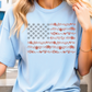 a woman wearing a blue shirt with an american flag on it