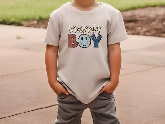 a little boy that is wearing a shirt that says mama's boy