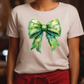 a woman wearing a white shirt with a green bow on it