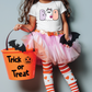 a little girl in a halloween costume holding a trick or treat bucket