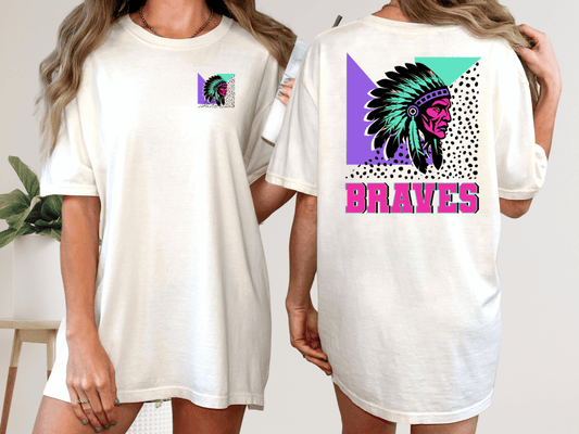 A woman wearing a white t-shirt with a colorful graphic design on the back, including a Native American headdress and the word "Braves" written below it.