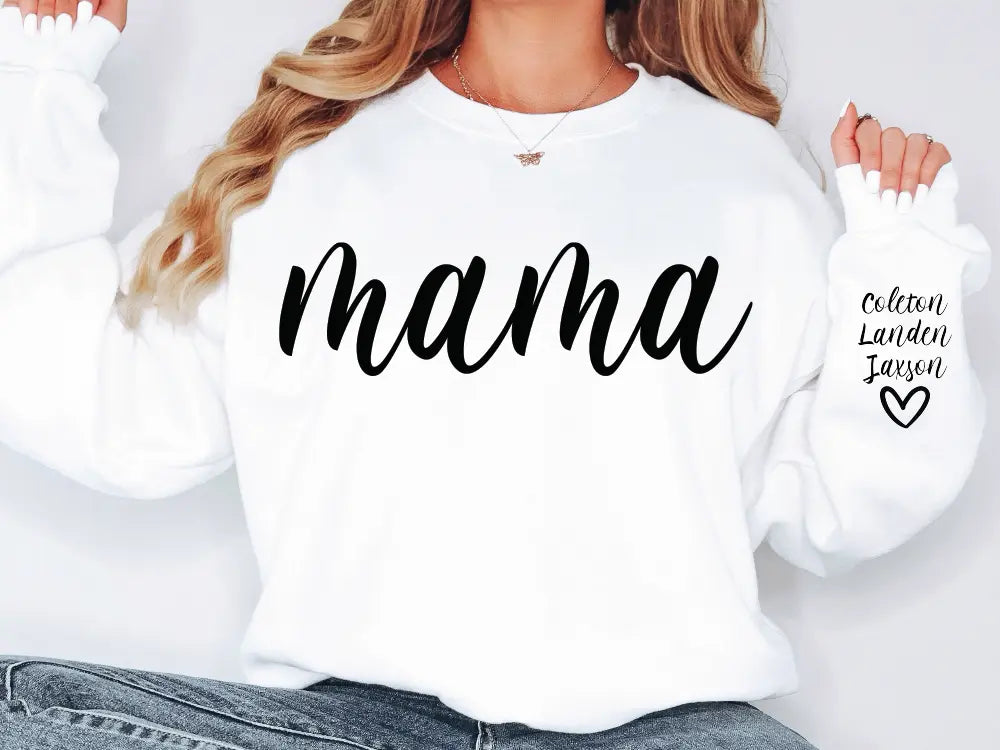 a woman wearing a white sweatshirt with the word mama printed on it