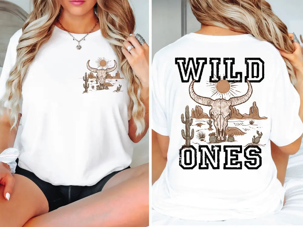 a woman sitting on a bed wearing a white shirt with wild ones on it