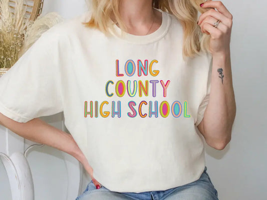 a woman sitting on a chair wearing a long county high school t - shirt